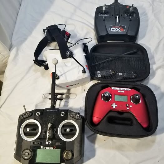 Drone bundle set with red-and-black controller, drone, and black carrying case