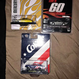 Diecast collectible car set in retail packaging, including Coke and black car models.