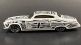 White diecast model car with bold black stripe graphics and black wheels