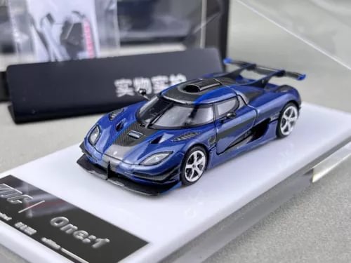 Blue racing diecast metal car model with black roof and hood detail, front 3/4 view