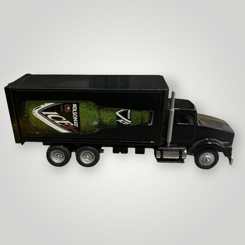 Diecast metal truck with black cab and green beer-logo trailer, 3-axle wheels