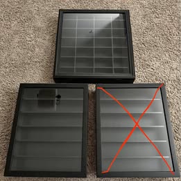 Black diecast car display case with gray grid and hinged doors, open view
