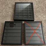 Black diecast car display case with gray grid and hinged doors, open view