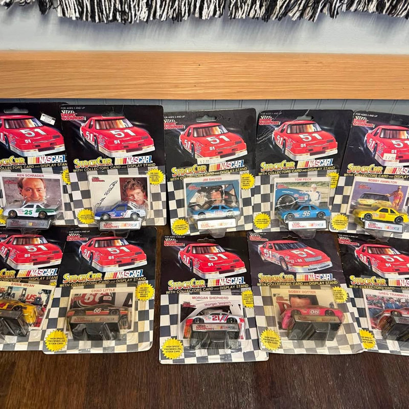Boxed NASCAR diecast cars lot with red race car models, in retail packaging