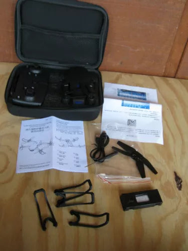 Foldable drone with black carrying case and accessories