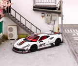 White 1:64 racing sports diecast model car with red accents and black wheels, side graphics