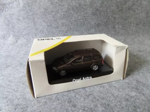 Boxed diecast estate car model with dark Opel Astra inside display window