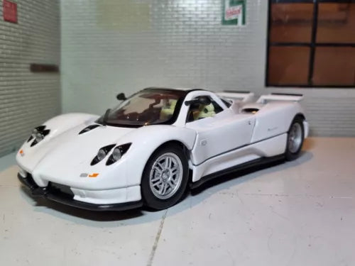 White diecast model sports car with black front splitter, front-left view