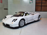 White diecast model sports car with black front splitter, front-left view