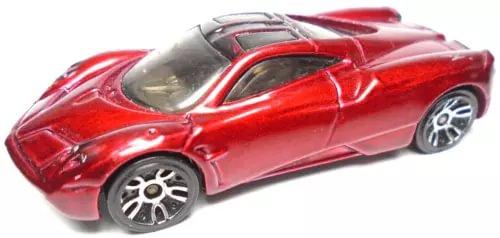 Red diecast race car model with silver rims, open-top cockpit, side view