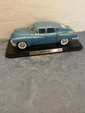 Blue 1948 Tucker sedan diecast metal model car with front grille on display base