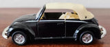Black diecast Volkswagen Beetle 1303 cabriolet model car with beige soft top