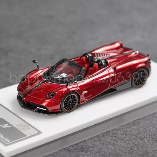 Red 1:64 convertible sports car model with open cockpit and alloy wheels