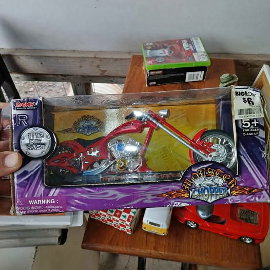 Red and black diecast monster chopper model in retail box