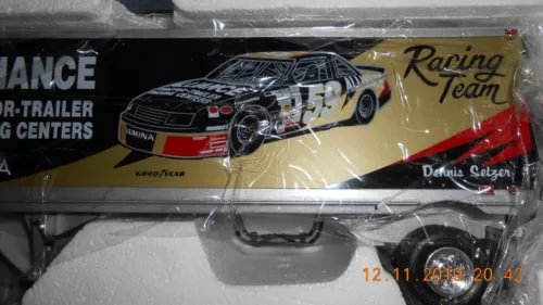 Diecast race tractor-trailer model, black with red stripe and exposed wheels