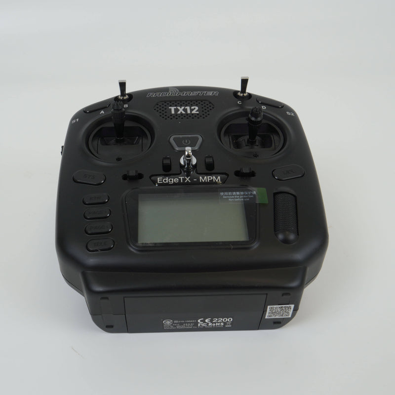 Black FPV remote controller with dual joysticks, LCD screen, and TX12 antenna mounts