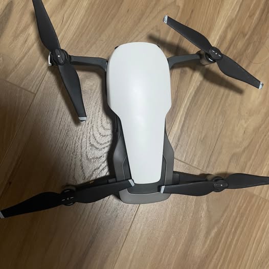 White drone with four black propeller arms