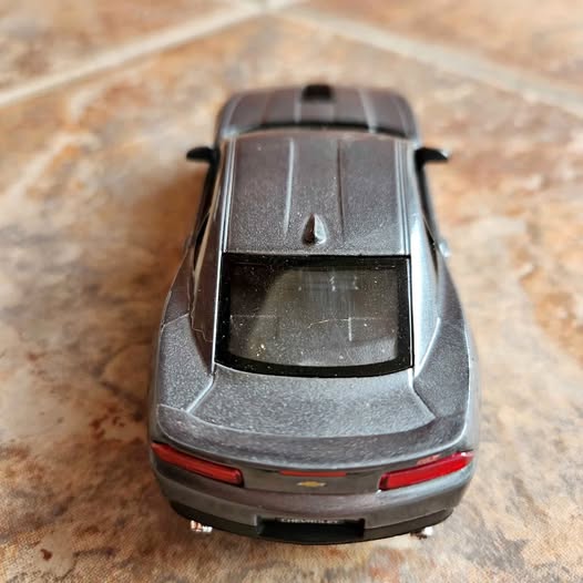 Gray diecast 2014 Camaro model, rear view with spoiler and taillights