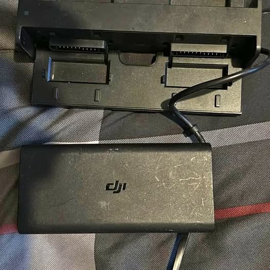 DJI remote controller, black with DJI logo and connected cable