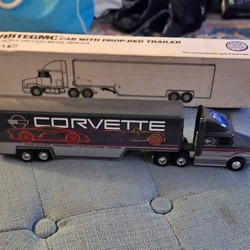 Diecast semi truck with black cab and white drop trailer, Corvette graphics