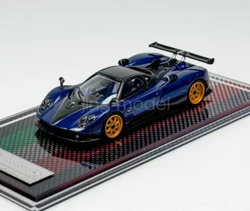 1:64 scale blue racing sports car diecast model with rear wing on track base