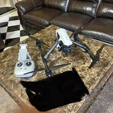 DJI Inspire 1 drone with white remote controller and black propellers on a case