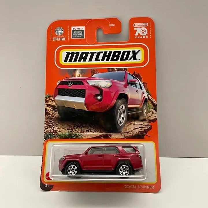 Red Matchbox diecast Toyota 4Runner SUV in blister packaging, front and side view