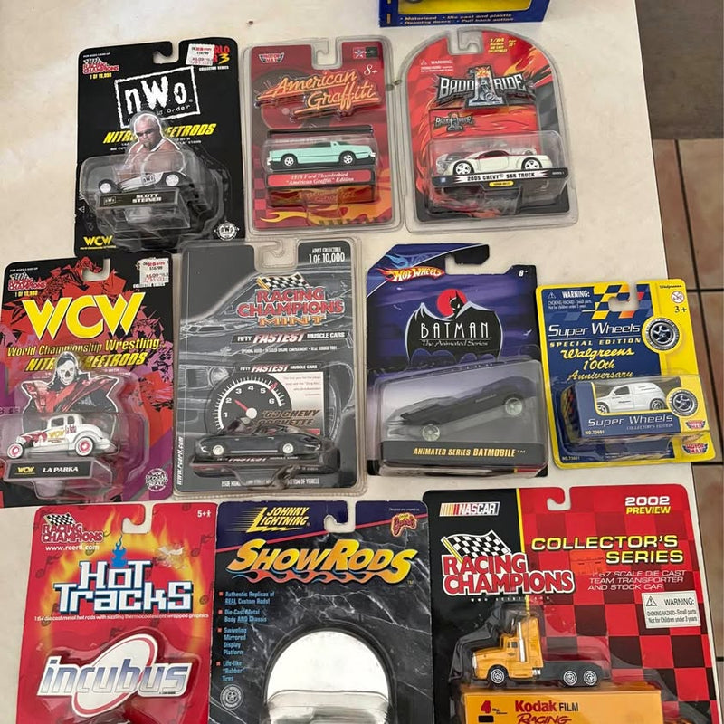 Assorted diecast car collectible blister packs with multiple car models