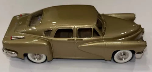 Olive-gold vintage die-cast torpedo car model with whitewall tires and chrome bumper