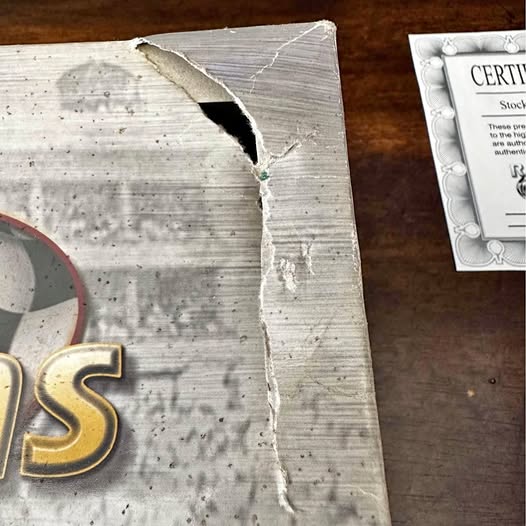 Autographed diecast set certificate with torn edge and gold letter S detail