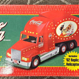 Red Coca-Cola diecast delivery truck with front grille and Santa-themed cab
