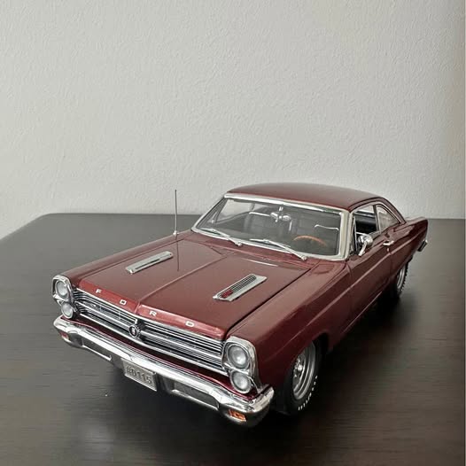 Maroon classic diecast model car, front three-quarter view with chrome details