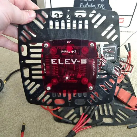 Drone quadcopter frame with red control circuit board and mounting holes