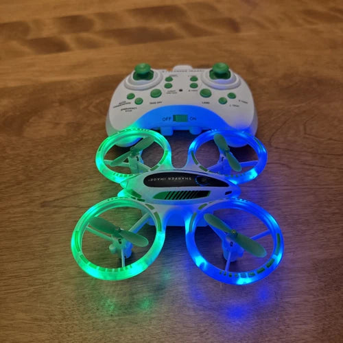 White LED stunt quadcopter drone with green and blue light rings