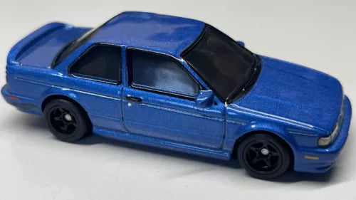 1991 Nissan Sentra SE-R diecast toy car, blue body, black wheels and windows, side view