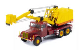Diecast model truck with maroon cab and yellow crane boom, striped base