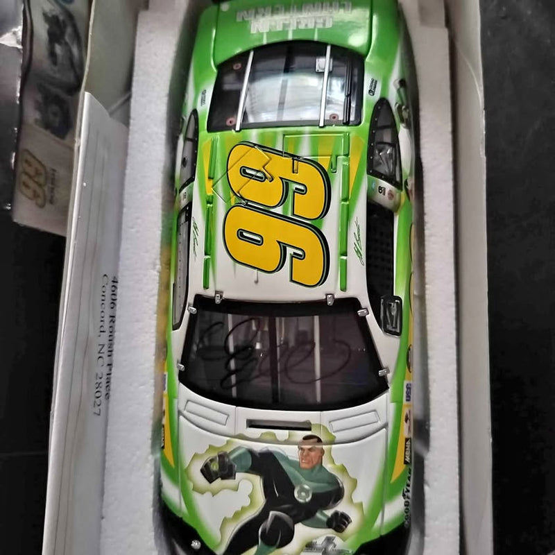 Diecast NASCAR race car model #99, green and white with driver figure in cockpit