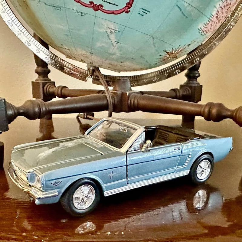 Light blue Ford Mustang convertible diecast car, front 3/4 view