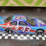 Blue diecast race car with #43 on side and Hamburger Helper logo, front view