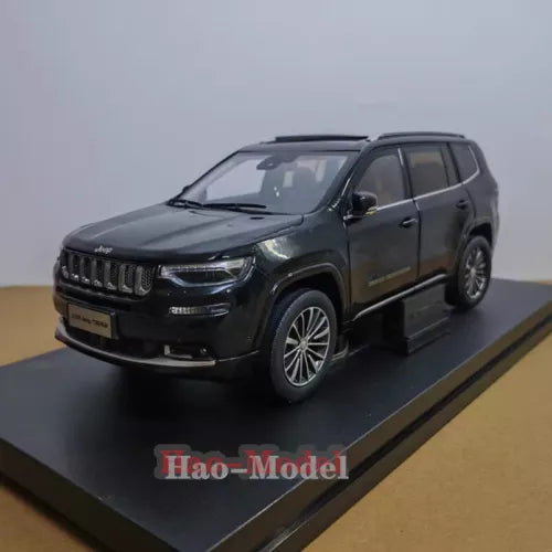 Diecast SUV model car in dark green with black grille, front 3/4 view