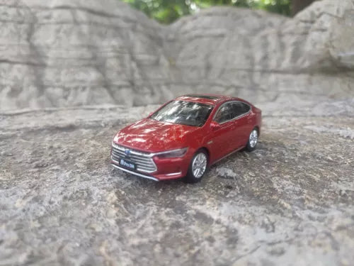 Red 1:43 BYD QIN Pro DM sedan diecast model car, front 3/4 view