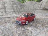 Red 1:43 BYD QIN Pro DM sedan diecast model car, front 3/4 view