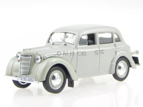 Beige vintage diecast model sedan car with chrome grille, front three-quarter view