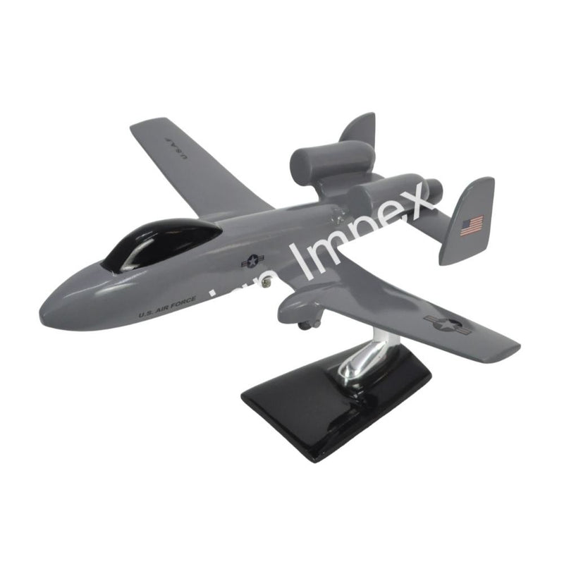 Grey fighter jet model with propeller detailing on black display base