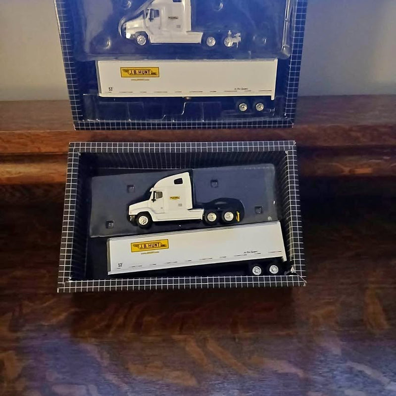 JB Hunt diecast truck model with white cab and yellow logo, in display box