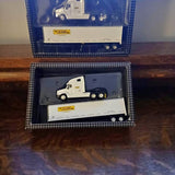 JB Hunt diecast truck model with white cab and yellow logo, in display box