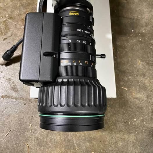 Compact black video camera with attached lens and battery module