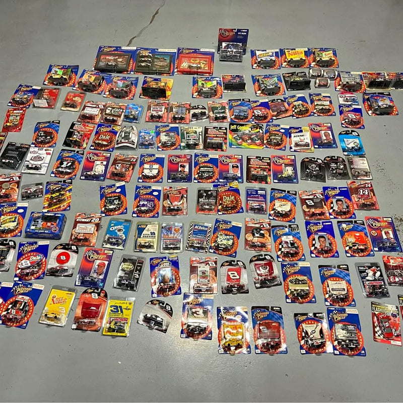 Assorted 1/64 diecast race car lot with multiple boxed cars and drivers