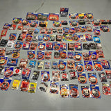 Assorted 1/64 diecast race car lot with multiple boxed cars and drivers