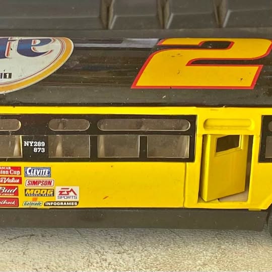 Yellow diecast bus with side windows and open-style door, printed decals